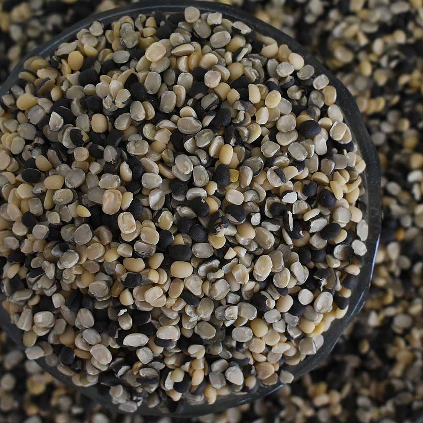 Split black urad dal with skin in a bowl